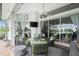 Cozy covered patio featuring comfortable seating, a ceiling fan, and sliding glass doors to the interior at 1417 Carswell St, Port Charlotte, FL 33953