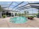Stunning pool and spa area featuring clear blue water and ample space for relaxation at 1417 Carswell St, Port Charlotte, FL 33953