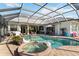 Spacious screened-in pool and spa with ample patio space for entertaining and relaxation at 1417 Carswell St, Port Charlotte, FL 33953