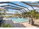 Inviting screened pool with a view of the pond, ideal for relaxing and enjoying the outdoors at 1417 Carswell St, Port Charlotte, FL 33953