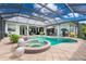 Inviting pool and spa surrounded by lush landscaping and ample seating areas at 1417 Carswell St, Port Charlotte, FL 33953