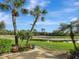 A charming backyard overlooks a serene lake, enhancing the property's appeal at 1616 Palmetto Palm Way, North Port, FL 34288