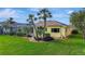 Inviting backyard features mature landscaping, a screened-in pool, and a well-maintained lawn at 1616 Palmetto Palm Way, North Port, FL 34288