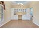 Dining room with decorative chandelier, custom built-in cabinets, and large windows at 1616 Palmetto Palm Way, North Port, FL 34288
