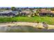 A well-kept yellow home features a screened-in pool and faces a beautiful lake at 1616 Palmetto Palm Way, North Port, FL 34288