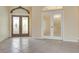 Bright foyer featuring double entry doors with decorative glass and decorative transom at 1616 Palmetto Palm Way, North Port, FL 34288