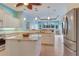 Open kitchen with granite counters, stainless appliances, and view to breakfast nook at 1616 Palmetto Palm Way, North Port, FL 34288