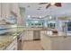 Well-equipped kitchen with white cabinetry, granite counters, stainless appliances, and natural light at 1616 Palmetto Palm Way, North Port, FL 34288
