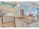 Kitchen area featuring granite counters, stainless sink, and open access to living area at 1616 Palmetto Palm Way, North Port, FL 34288