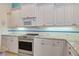 Stylish kitchen showcasing granite countertops, stainless steel oven, and white cabinets at 1616 Palmetto Palm Way, North Port, FL 34288