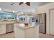 Bright kitchen with stainless steel appliances, granite countertops, island and backyard views at 1616 Palmetto Palm Way, North Port, FL 34288