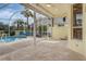 Spacious covered lanai overlooking the pool and tropical landscaping, perfect for entertaining at 1616 Palmetto Palm Way, North Port, FL 34288