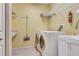 Convenient laundry room with washer, dryer, sink, counter space, and storage shelves at 1616 Palmetto Palm Way, North Port, FL 34288