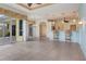 Bright, open-concept living area featuring tile flooring, bar seating, and access to a screened patio at 1616 Palmetto Palm Way, North Port, FL 34288
