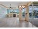 Spacious living room with tile floors, fireplace, built-in shelving, and sliding glass doors to the outdoor pool area at 1616 Palmetto Palm Way, North Port, FL 34288