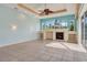 Inviting living room with a fireplace, built-in shelving, decorative ceiling fan, and bright natural light at 1616 Palmetto Palm Way, North Port, FL 34288
