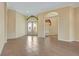 Spacious living room with tiled floors, decorative entry door, with view to open-concept layout at 1616 Palmetto Palm Way, North Port, FL 34288