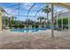 A screen enclosed pool overlooking the tropical landscaping at 1616 Palmetto Palm Way, North Port, FL 34288