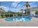 A pool with a screen enclosure and palm trees at 1616 Palmetto Palm Way, North Port, FL 34288