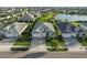 Aerial view of home showcasing three-car garage, and meticulously landscaped surroundings with nearby pond at 17917 Wayside Bnd, Punta Gorda, FL 33982