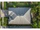 Overhead view shows a gray roof surrounded by well-maintained landscaping and a paved driveway at 17917 Wayside Bnd, Punta Gorda, FL 33982