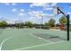 Community basketball court with benches, landscaping and black metal surrounding fence and lighting at 17917 Wayside Bnd, Punta Gorda, FL 33982