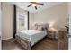 Bright bedroom featuring a queen bed, ceiling fan, and a window letting in natural light at 17917 Wayside Bnd, Punta Gorda, FL 33982