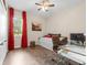 Bedroom space featuring a desk, daybed, ceiling fan, and window with red curtains at 17917 Wayside Bnd, Punta Gorda, FL 33982