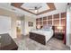 Bedroom featuring decorative ceiling and accent wall, and a view into the bathroom at 17917 Wayside Bnd, Punta Gorda, FL 33982