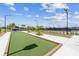 Community bocce ball court with synthetic turf and wooden borders, surrounded by landscaping at 17917 Wayside Bnd, Punta Gorda, FL 33982