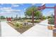 Landscaped entry to Jack Peeples Park featuring manicured foliage and a decorative rock at 17917 Wayside Bnd, Punta Gorda, FL 33982