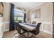 Dining area has modern chandelier, white table with seating for six, and blue window treatments at 17917 Wayside Bnd, Punta Gorda, FL 33982