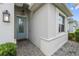 Charming entrance with a blue glass paneled door, brick paved walkway, and decorative lighting at 17917 Wayside Bnd, Punta Gorda, FL 33982