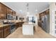 Bright kitchen features granite countertops, stainless steel appliances, and large kitchen island at 17917 Wayside Bnd, Punta Gorda, FL 33982