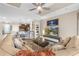 Comfortable living room with large sectional, decorative shelving, and open access to kitchen at 17917 Wayside Bnd, Punta Gorda, FL 33982