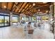 Inviting outdoor seating area with a fireplace, stone pillars, and ceiling fans at 17917 Wayside Bnd, Punta Gorda, FL 33982