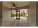 Screened patio with brick floors and ceiling fan overlooks lush landscaping and neighborhood at 17917 Wayside Bnd, Punta Gorda, FL 33982