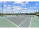 Daytime view of community pickleball courts with metal nets and covered bench seating at 17917 Wayside Bnd, Punta Gorda, FL 33982