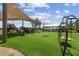 Community playground on green turf with covered picnic tables and slide and playground equipment at 17917 Wayside Bnd, Punta Gorda, FL 33982