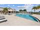 Beautiful swimming pool with lounge chairs, palm trees, and views of the surrounding buildings at 17917 Wayside Bnd, Punta Gorda, FL 33982