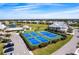 Aerial view of community tennis and pickleball courts near a pond and neighborhood homes at 2081 Willow Hammock Cir # F101, Punta Gorda, FL 33983