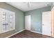 Bedroom with wood floors, double closet, and plantation shutters on the window at 2081 Willow Hammock Cir # F101, Punta Gorda, FL 33983