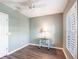 Bedroom with wood floors, a ceiling fan, white trim, and plantation shutters on the window at 2081 Willow Hammock Cir # F101, Punta Gorda, FL 33983