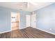 Bedroom with wood floors, closet, and doorway into the en-suite bathroom at 2081 Willow Hammock Cir # F101, Punta Gorda, FL 33983