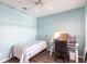 Bright bedroom with ceiling fan, desk, and single bed with blue and white bedding at 2081 Willow Hammock Cir # F101, Punta Gorda, FL 33983