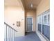 Condo entrance featuring unit number, storm door, and a white-framed window with privacy shutters at 2081 Willow Hammock Cir # F101, Punta Gorda, FL 33983