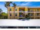 Three-story exterior view featuring stairways and attached carports at 2081 Willow Hammock Cir # F101, Punta Gorda, FL 33983