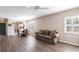 Well-lit living room featuring wood floors, dining area, comfortable couch, and white shuttered windows at 2081 Willow Hammock Cir # F101, Punta Gorda, FL 33983