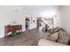 Spacious living room with wood floors, comfortable couch, dining area, and stylish cabinet at 2081 Willow Hammock Cir # F101, Punta Gorda, FL 33983
