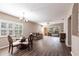 Open living and dining area with wood floors, chandelier, and sliding glass doors to a screened lanai at 2081 Willow Hammock Cir # F101, Punta Gorda, FL 33983
